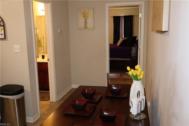 hallway featuring baseboards and wood finished floors