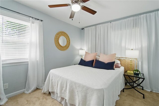 bedroom with carpet floors, a ceiling fan, and baseboards