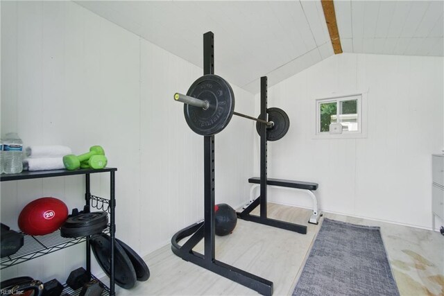 workout area with wood finished floors and lofted ceiling