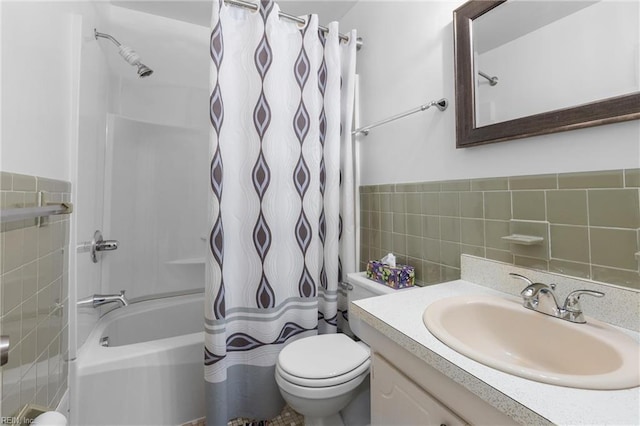 full bath with vanity, toilet, tile walls, and shower / tub combo