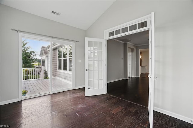 unfurnished room with visible vents, lofted ceiling, wood finished floors, baseboards, and french doors
