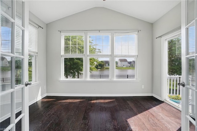 unfurnished sunroom featuring a water view, french doors, and a wealth of natural light