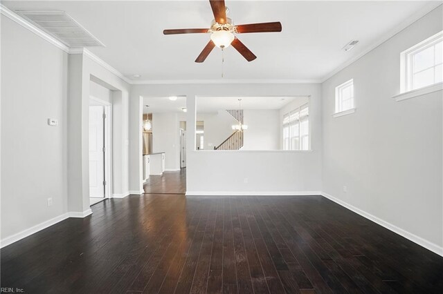 unfurnished living room with crown molding, plenty of natural light, ceiling fan with notable chandelier, and dark wood-type flooring