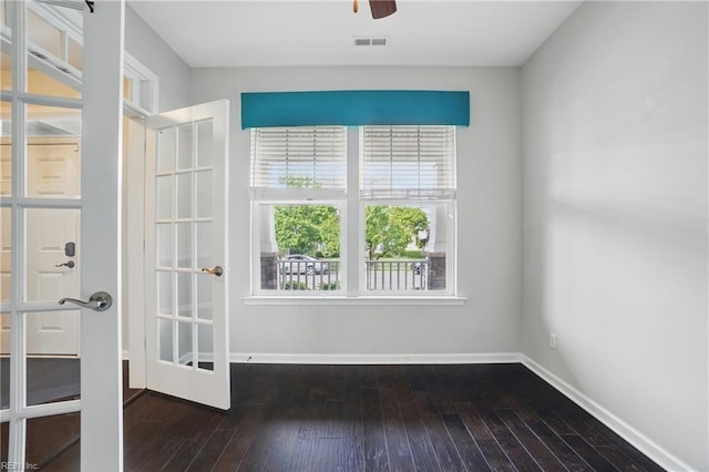 empty room featuring baseboards, ceiling fan, wood-type flooring, and visible vents