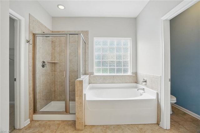 full bath featuring tile patterned floors, a stall shower, toilet, and a garden tub