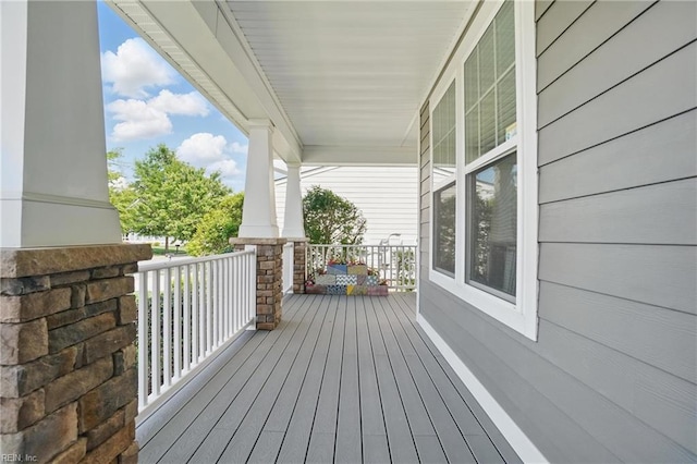 wooden terrace featuring covered porch