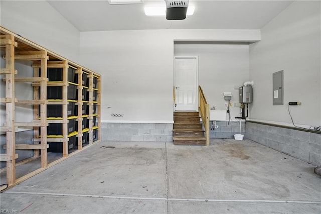 garage with electric panel and concrete block wall