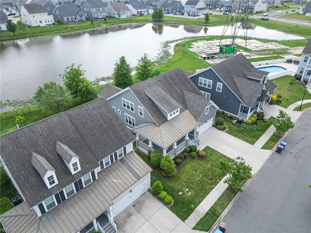 birds eye view of property with a water view and a residential view