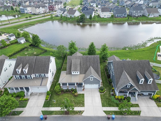 birds eye view of property with a water view and a residential view