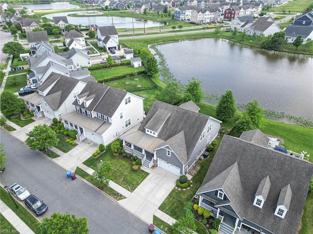 birds eye view of property featuring a water view and a residential view