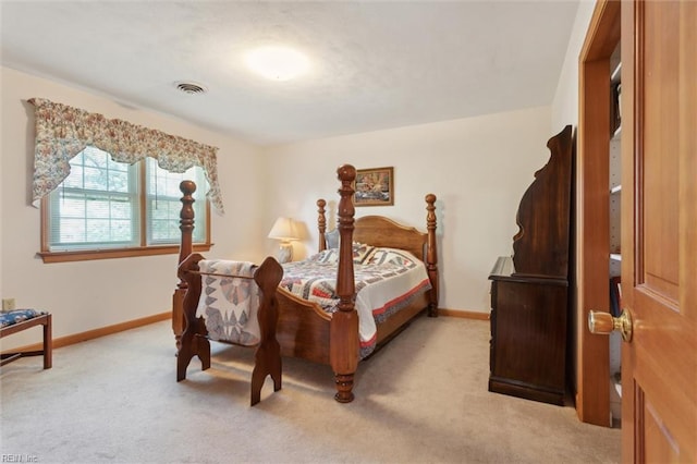 bedroom with light colored carpet, baseboards, and visible vents