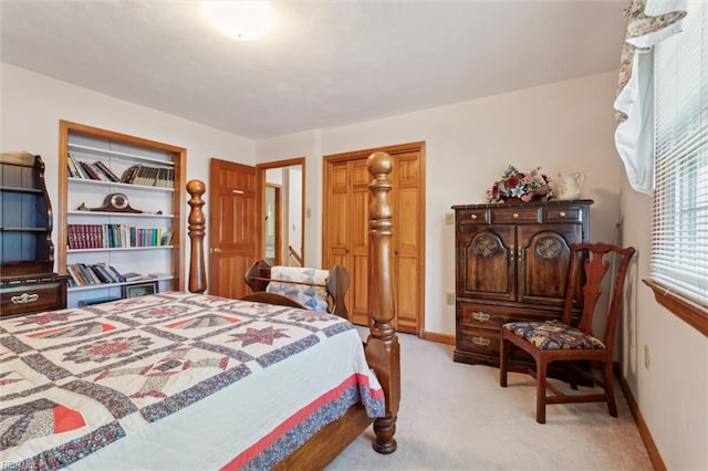 bedroom with baseboards and light carpet