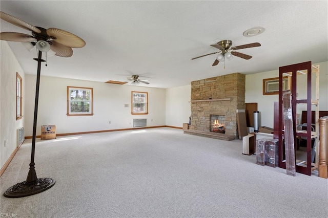 unfurnished living room featuring baseboards, carpet, a ceiling fan, and visible vents