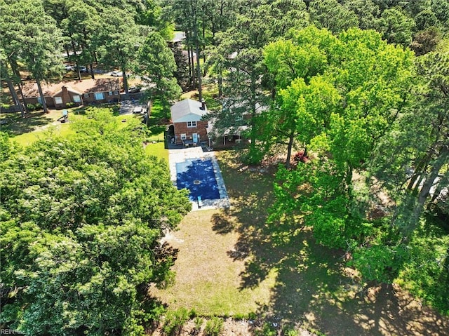 birds eye view of property featuring a view of trees
