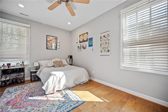 bedroom with visible vents, baseboards, and multiple windows