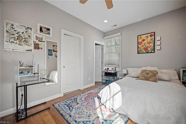 bedroom featuring visible vents, wood finished floors, baseboards, recessed lighting, and a ceiling fan