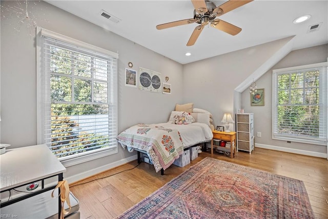 bedroom with baseboards, wood-type flooring, recessed lighting, and visible vents