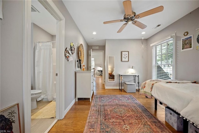bedroom featuring light wood-style flooring, recessed lighting, baseboards, ensuite bathroom, and visible vents