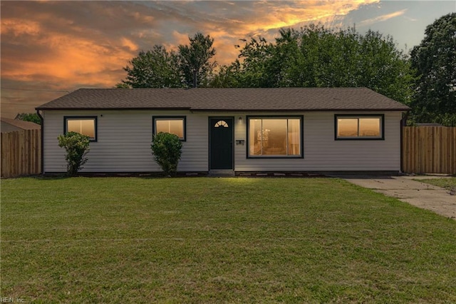 ranch-style house with fence and a front yard