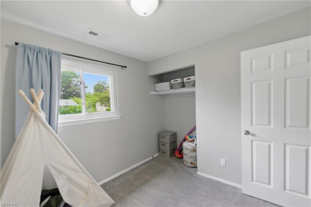 bedroom with baseboards, carpet, visible vents, and a closet