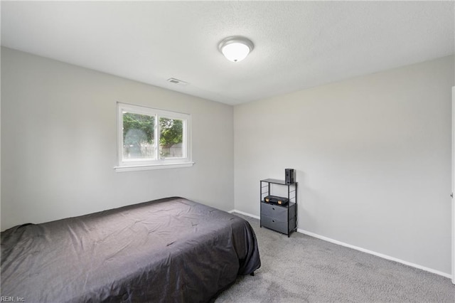 carpeted bedroom with baseboards and visible vents