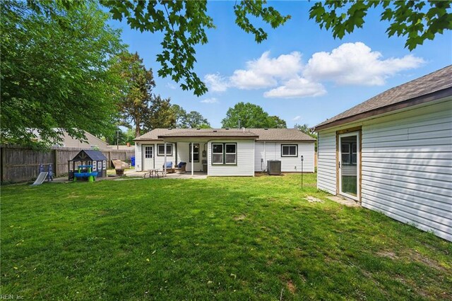 back of house featuring a yard, central AC, fence, and a patio area