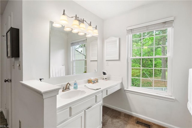 bathroom with baseboards and vanity