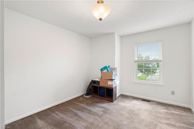 empty room with carpet flooring and baseboards
