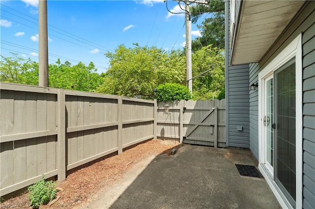 view of patio / terrace featuring fence and a gate
