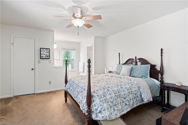 carpeted bedroom featuring ceiling fan and baseboards