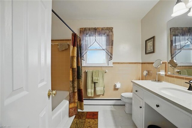 bathroom with tile walls, baseboard heating, tile patterned floors, vanity, and toilet