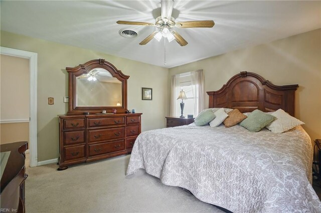 bedroom with ceiling fan, visible vents, and light carpet
