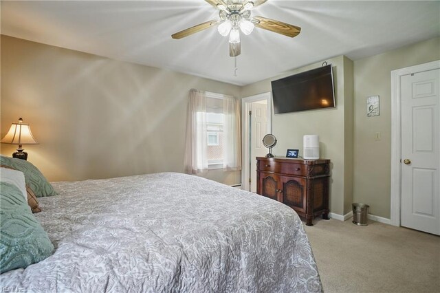 carpeted bedroom with baseboards and a ceiling fan