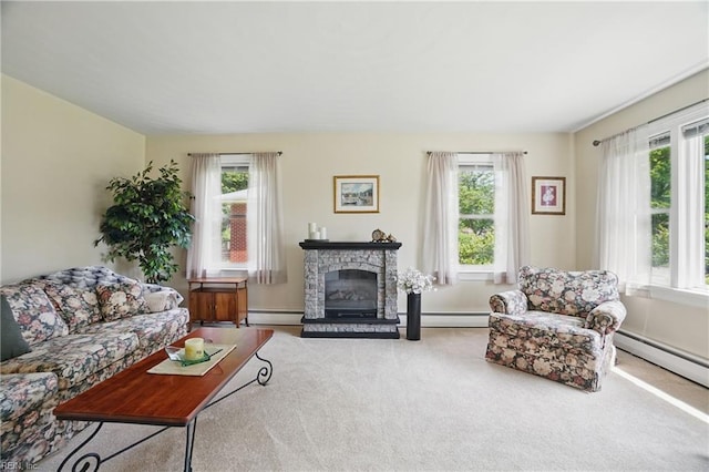 carpeted living room featuring a baseboard heating unit and a stone fireplace