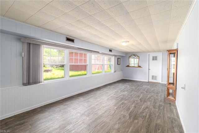 unfurnished living room with baseboards, wood finished floors, and visible vents