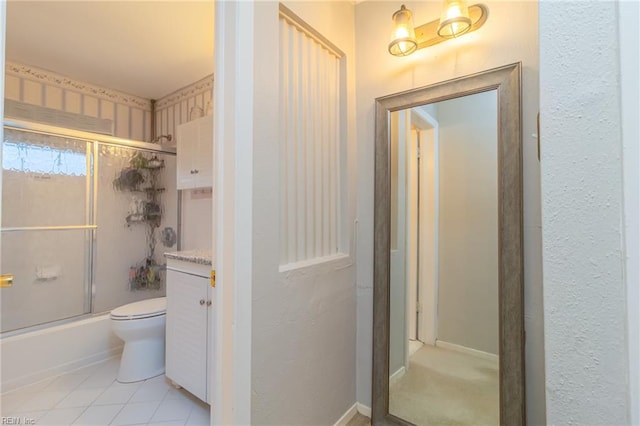 bathroom with toilet, enclosed tub / shower combo, tile patterned flooring, and vanity