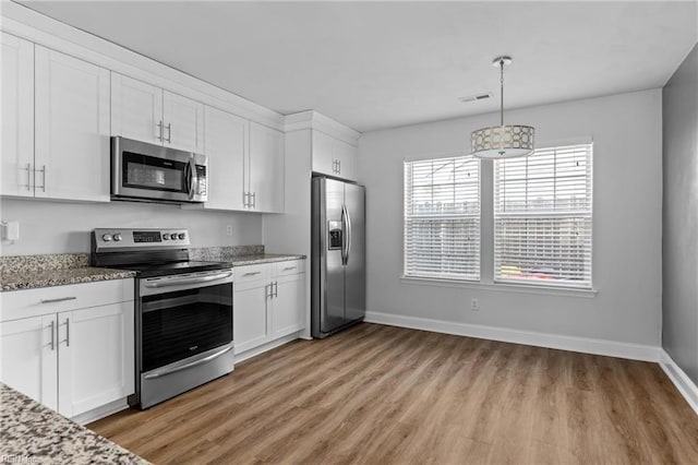 159 Stoney Ridge Ave, Suffolk, VA 23435 - kitchen with white cabinets, stainless steel appliances, and light wood-style flooring