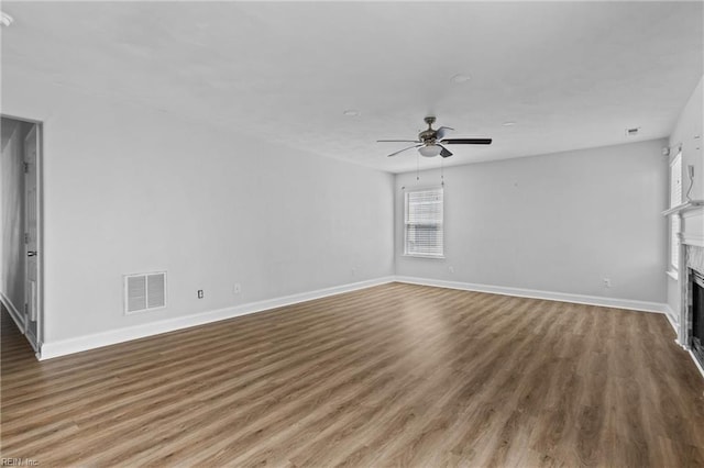 159 Stoney Ridge Ave, Suffolk, VA 23435 - unfurnished living room featuring a ceiling fan, visible vents, a fireplace, wood finished floors, and baseboards