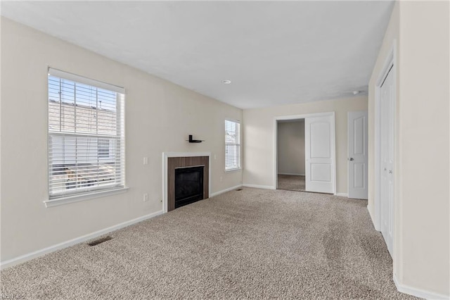 159 Stoney Ridge Ave, Suffolk, VA 23435 - unfurnished living room with a glass covered fireplace, baseboards, carpet flooring, and visible vents