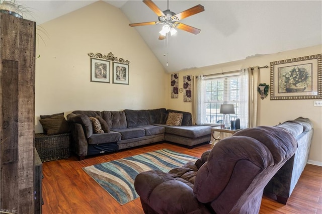 living area featuring high vaulted ceiling, a ceiling fan, and wood finished floors