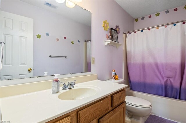 bathroom featuring toilet, visible vents, shower / tub combo with curtain, and vanity