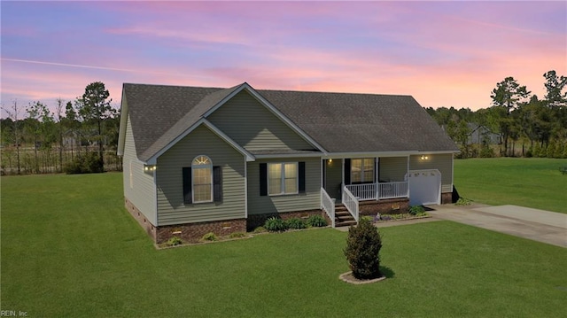 view of front of home featuring a porch, a garage, a front lawn, concrete driveway, and a shingled roof