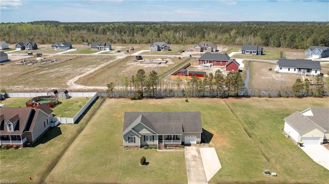 drone / aerial view with a wooded view
