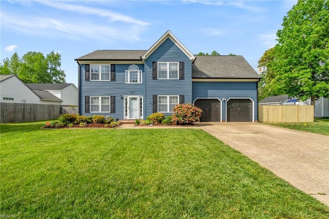 view of front of house with fence, driveway, a front lawn, and a garage