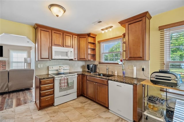 kitchen featuring a sink, plenty of natural light, and white appliances