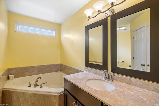 bathroom with a garden tub, a notable chandelier, and vanity
