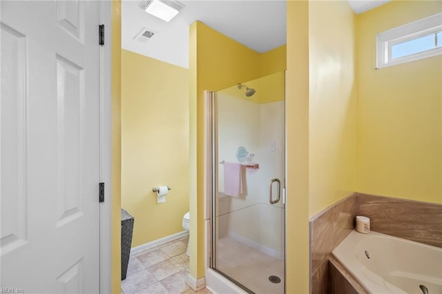 bathroom featuring toilet, baseboards, a shower stall, visible vents, and a garden tub