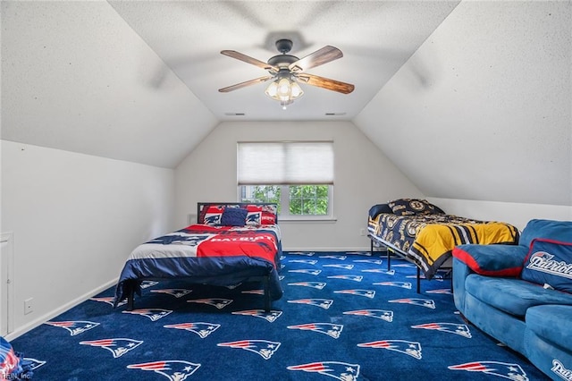 bedroom with carpet flooring, a textured ceiling, and vaulted ceiling