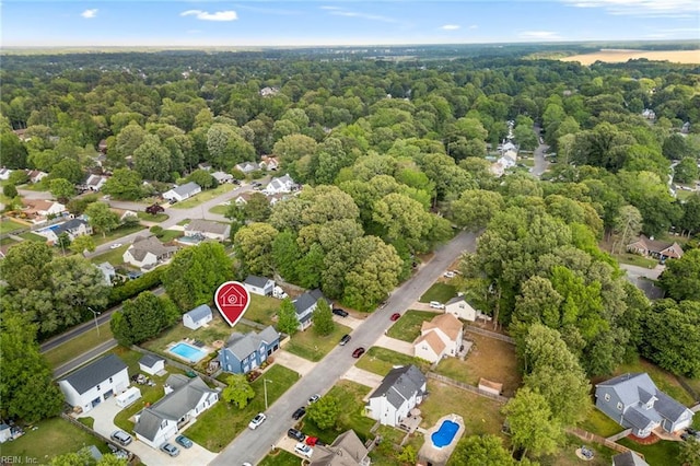 birds eye view of property with a residential view and a wooded view