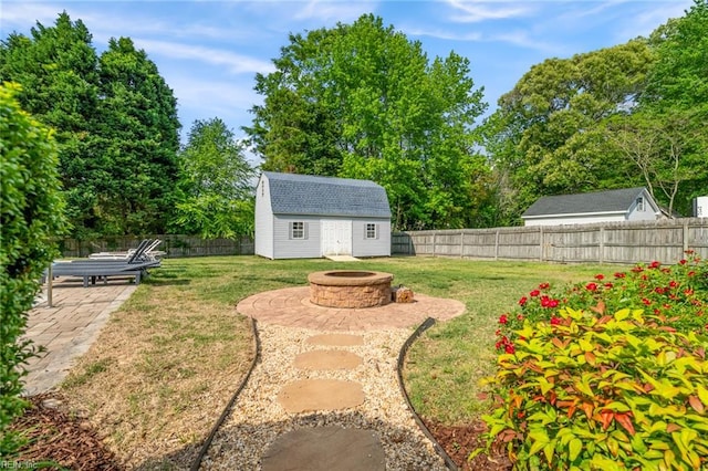 view of yard featuring a fenced backyard, a fire pit, and a patio area